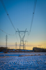 High voltage electricity transmission towers by aerial cables in winter
