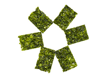 Green seaweed chips, isolated on a white background. Korean healthy snack, healthy food. Close-up view. © golubka57