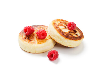 Cottage cheese fritters or syrniki with fresh raspberries. Tasty dessert or sweet breakfast. Russian, Ukrainian cuisine food. isolated on white background
