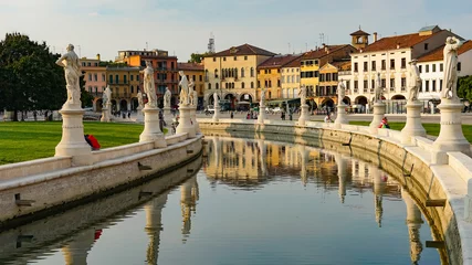 Deurstickers PADUA, ITALY - OCTOBER, 2017: Piazza Prato della Valle on Santa Giustina abbey. Prato della Valle elliptical square, surrounded by a small canal and bordered by two rings of statues. © merlin74
