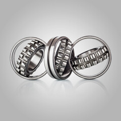 Composition of steel ball bearings in closeup. Ball-bearings, pinions against brushed aluminum, titanium and steel aerospace parts