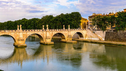 Fototapeta na wymiar It's Angels Bridge in the Historic Center of Rome, Italy. Rome is the capital of Italy and a popular touristic destination
