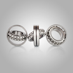 Composition of steel ball bearings in closeup. Ball-bearings, pinions against brushed aluminum,...