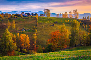 Fototapeta na wymiar Majestic autumn countryside scenery with houses on the hills, Romania