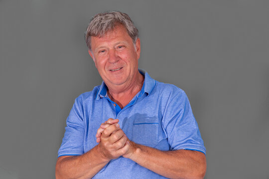 Portrait Of Sixty Year Old Attractive Senior Man In Blue Shirt