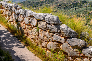 It's Ruins of Mycenae, center of Greek civilization, Peloponnese, Greece. Mycenae is a famous archaeological site in Greece. UNESCO World Heritage Site
