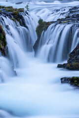 Obraz premium Beautiful and powerful of white streaming at Bruarfoss waterfall and black lava rock around waterfall in evening,Summer,Iceland. 