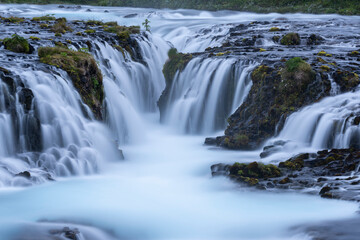 Fototapeta premium Beautiful and powerful of white streaming at Bruarfoss waterfall and black lava rock around waterfall in evening,Summer,Iceland. 