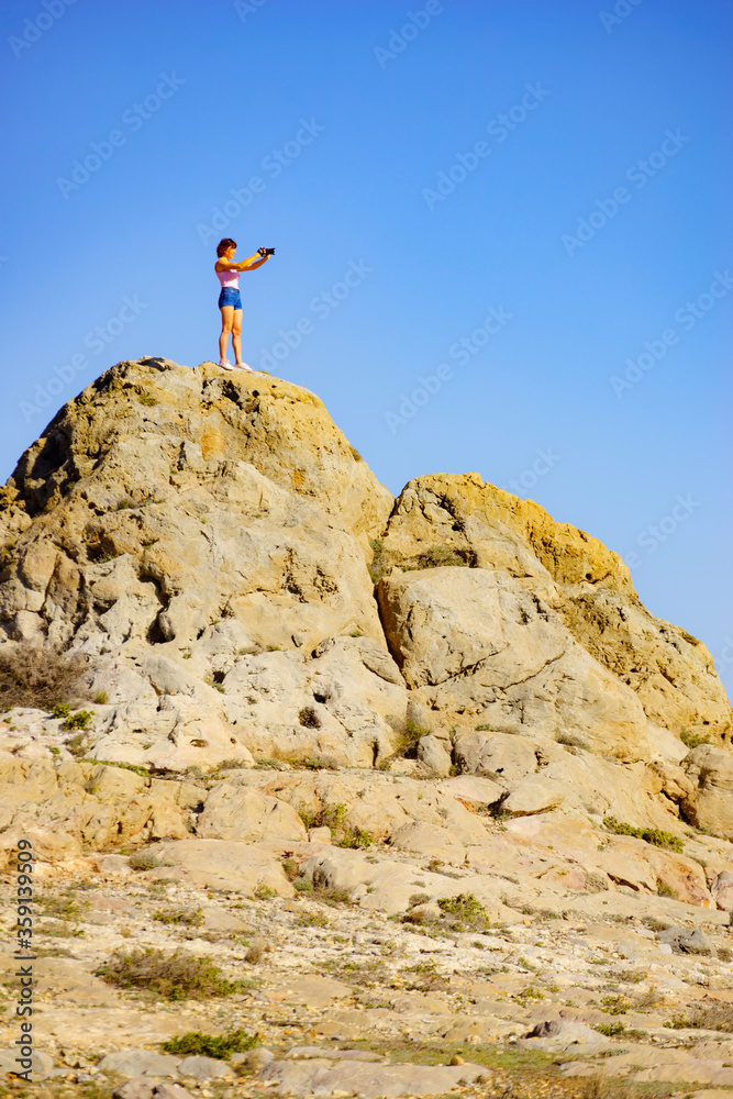 Wall mural woman with camera take travel photo