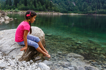 little girl looking to italy mountains
