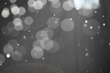 Abstract background with highlights and bokeh from splashing water, light from lanterns and the sun