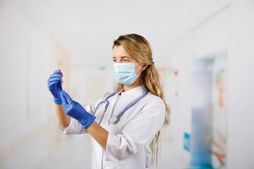 Doctor hold on blood sample tube for corona virus test , COVID 19 test