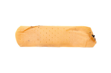Used antibacterial patch on a white background in macro. Dirty patch, orange yellow top and side view