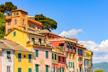 Fototapeta na wymiar It's Close view of the colorful houses in Portofino, an Italian fishing village, Genoa province, Italy. A vacation resort with a picturesque harbour and with celebrity and artistic visitors.