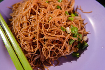 Popular local breakfast delight in Singapore — close up of fried bee hoon with spring onions. Favourite hawker food; Maxwell Food Centre