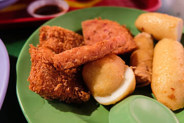 Popular local breakfast delights in Singapore — close up of fried snacks (luncheon meat, fish...