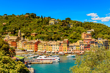 Fototapeta na wymiar It's Panoramic view of Portofino, is an Italian fishing village, Genoa province, Italy. A vacation resort with a picturesque harbour and with celebrity and artistic visitors.