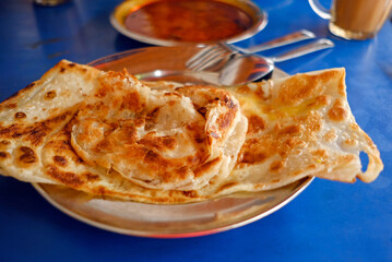 Local breakfast of Prata and curry (Indian cuisine) at Casuarina, a popular breakfast delight in Singapore. A local favourite among Singaporeans.