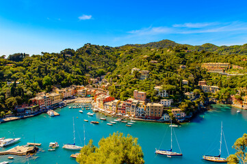 Fototapeta na wymiar It's Aerial view of Portofino, is an Italian fishing village, Genoa province, Italy. A vacation resort with a picturesque harbour and with celebrity and artistic visitors.