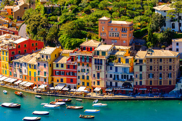 Fototapeta na wymiar It's Aerial view of Portofino, an Italian fishing village, Genoa province, Italy. A vacation resort with a picturesque harbour and with celebrity and artistic visitors.