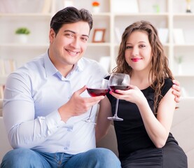 Young pair drinking wine in romantic concept