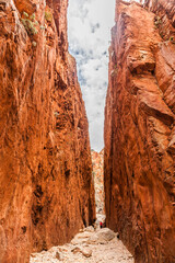Landscape along Standley Chasm track to Standley Chasm Gorge and the famous Larapinta Trail in the West MacDonnell Ranges during the Australian summer with fantastic green plants and red rocks