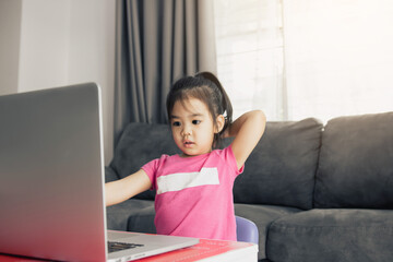 Kindergarten students are learning online with teachers and friends chatting on video on a computer while the school is closed while the virus is spreading.