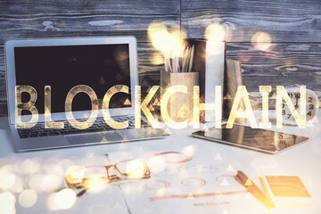 Double exposure of blockchain and crypto economy theme hologram and table with computer background....