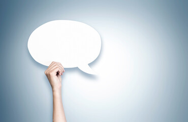 Woman hand holding blank speech bubble