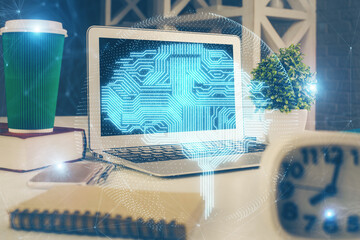 Double exposure of work space with computer and human brain drawing hologram. Brainstorm concept.