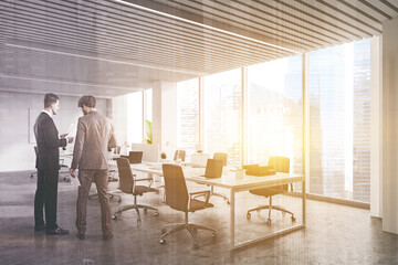Two businessmen in panoramic white office
