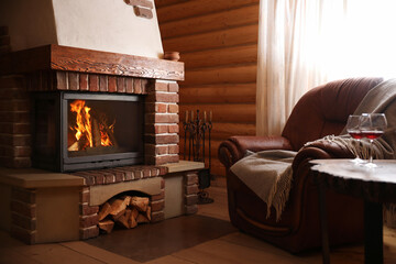 Modern cottage interior with stylish furniture and fireplace. Winter vacation