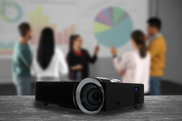 Modern video projector and blurred people on background - obrazy, fototapety, plakaty