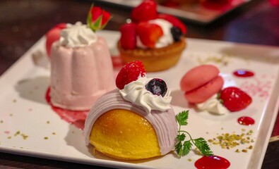 3 different cakes on a white plate with decoration with focus on the cake in the front