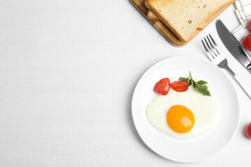 Tasty fried egg served with bread on white wooden table, flat lay. Space for text