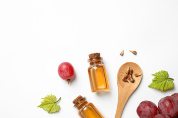 Composition with bottles of natural grape seed oil on white background, top view. Organic cosmetic