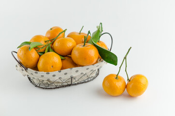 Fresh mandarin oranges fruit or tangerines with leaves on white background