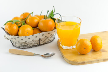 Mandarin juice and fresh mandarin fruits on white background