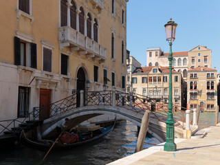Fototapeta na wymiar A gondola passing under a bridge on the Rio de San Vio Canal leading into the Grand Canal, Venice, Italy