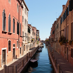Fototapeta na wymiar Moored boats line the Rio de la Fornace Canal, Venice, Italy