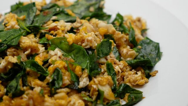 Close-Up Footage of Bai Lieng Pad Kai (Stir-fried Malindjo leaves with Egg), One of Famous Southern of Thailand Street Food