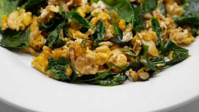 Close-Up Footage of Bai Lieng Pad Kai (Stir-fried Malindjo leaves with Egg), One of Famous Southern of Thailand Street Food