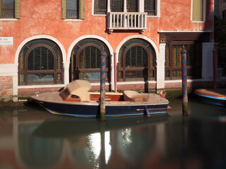 A moored boat on the Rio Del Magazen canal, Venice, Italy