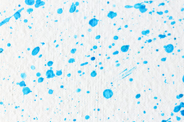 Blue paint splashes on white canvas as background. Art and creativity