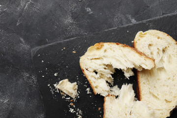Sliced fresh white bread on a dark table
