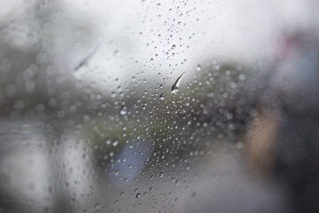 Obraz premium View on road in rain through wind-screen of moving car. Bad rainy weather.