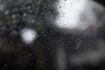 View on road in rain through wind-screen of moving car. Bad rainy weather.