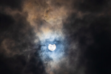 Naklejka na ściany i meble Surreal Dramatic Solar Eclipse Covered By Clouds. Natural Phenomenon.