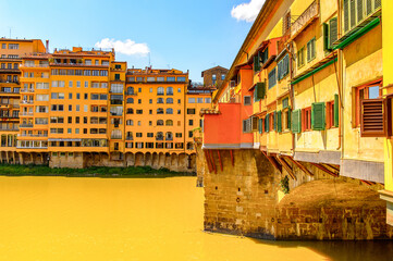 It's Ponte Vecchio (Old Bridge), a Medieval stone closed-spandrel segmental arch bridge over the Arno River, in Florence, Italy.