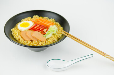 Korean spicy soup noodles ramen with sausage, chili, egg, and vegetables